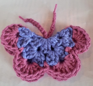 Fold petals together to form crochet butterfly